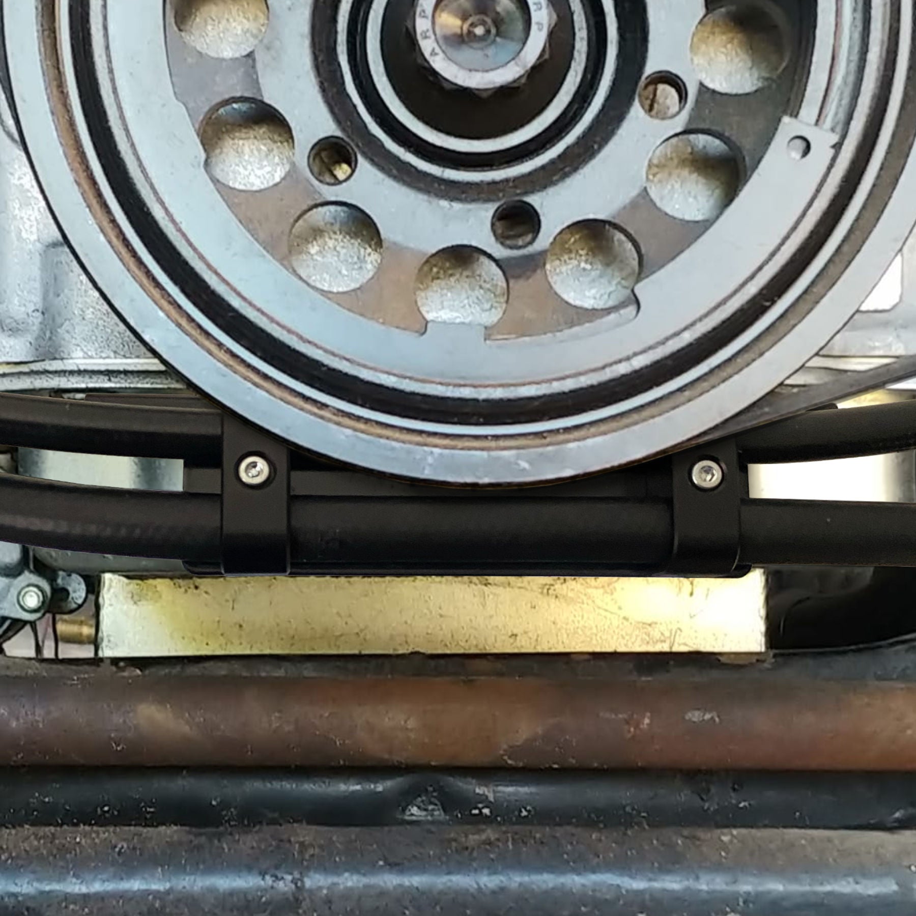 Power steering line bracket mounted under HQ LS1 showing hose routing